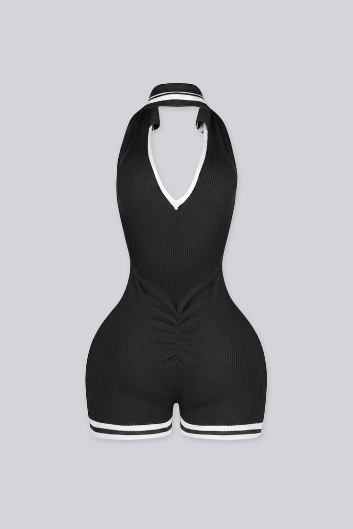 EDGEBYKS - Ribbed knit sleeveless collared romper featuring a plunging halter neckline, black back view