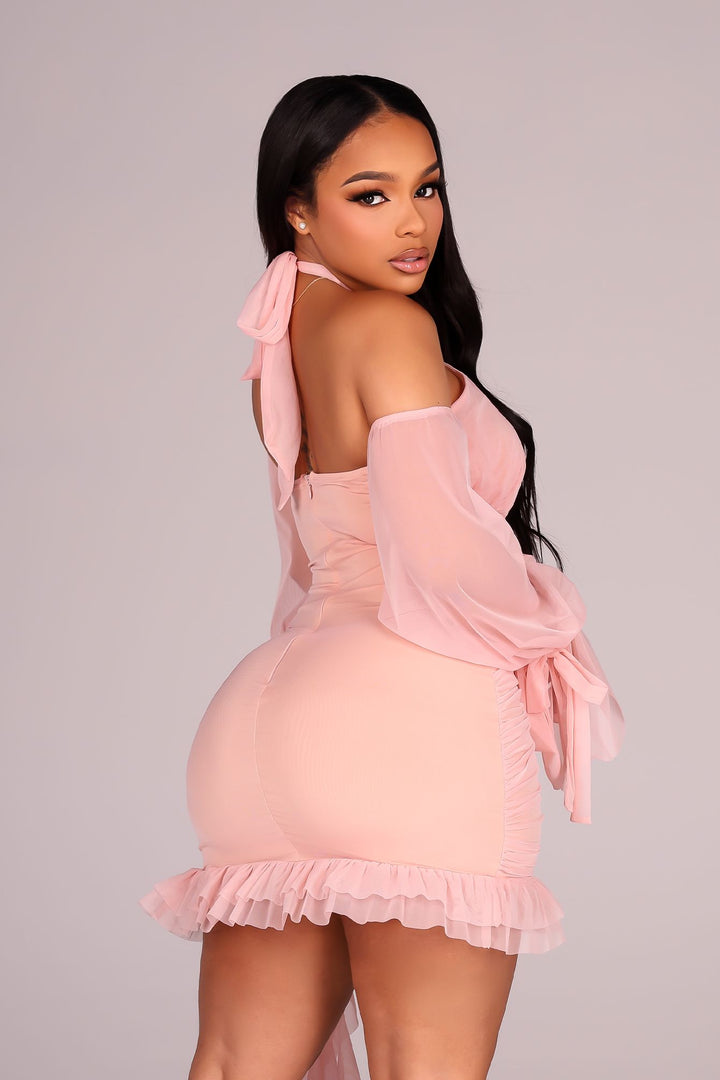 Ruched bodycon mini dress with a ruffled hem, lace trim detail, and nude tone lining
Mesh halter neckline with off shoulder long sleeves