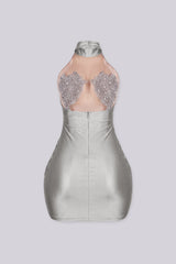 Sleeveless halter mini dress with an illusion nude mesh paneling with rhinestone accents
