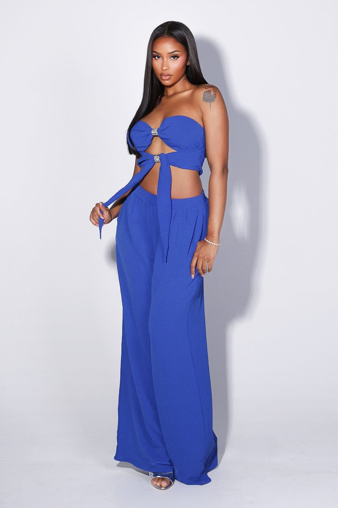 Chiffon tube top featuring central front cutout detailing with rhinestone buckle accent
Matching high waist wide leg pants with elastic waistband