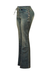 High rise vintage wash denim jeans featuring lace up details at center and outer hip sides