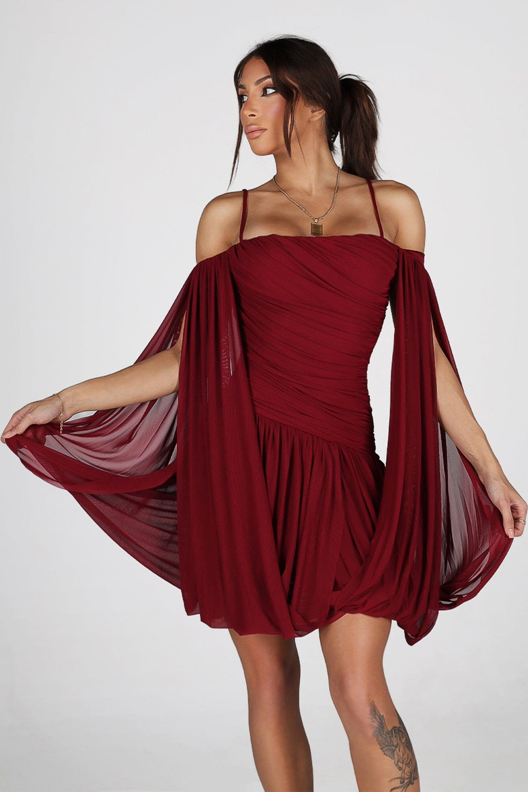 Sheer mesh mini dress with thin straps featuring oversized bishop sleeves balloon out from the shoulder
