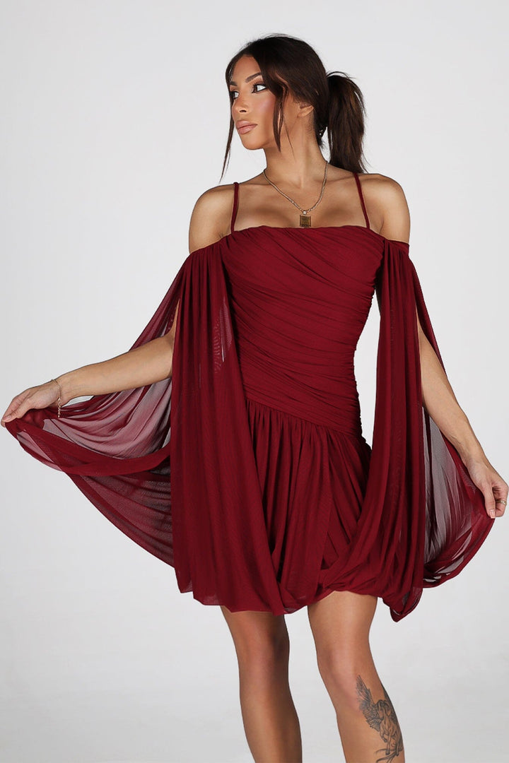 Sheer mesh mini dress with thin straps featuring oversized bishop sleeves balloon out from the shoulder