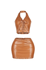 Stretched faux leather halter top featuring lace up with snap button closure
Matching high waisted faux leather mini skirt with lace up trim and back zip closure