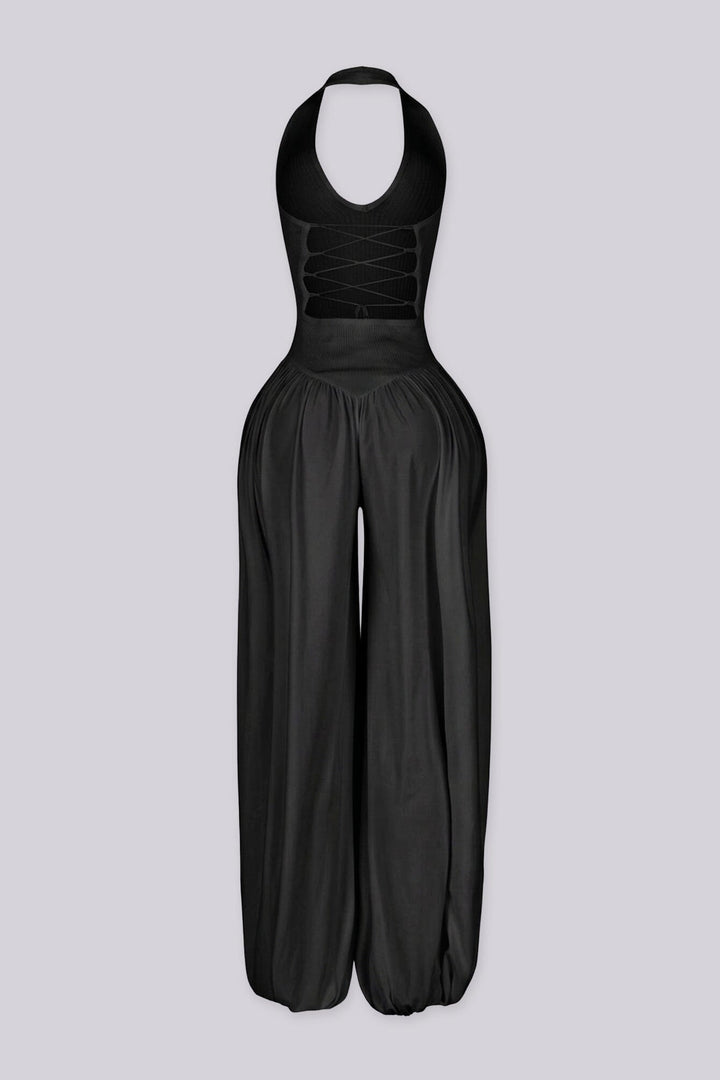 Ribbed knit halter neckline jumpsuit with voluminous balloon leg silhouette
Open back with lace-up closure