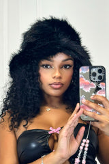 EDGE — black faux fur bucket hat worn by a model in a mirror selfie