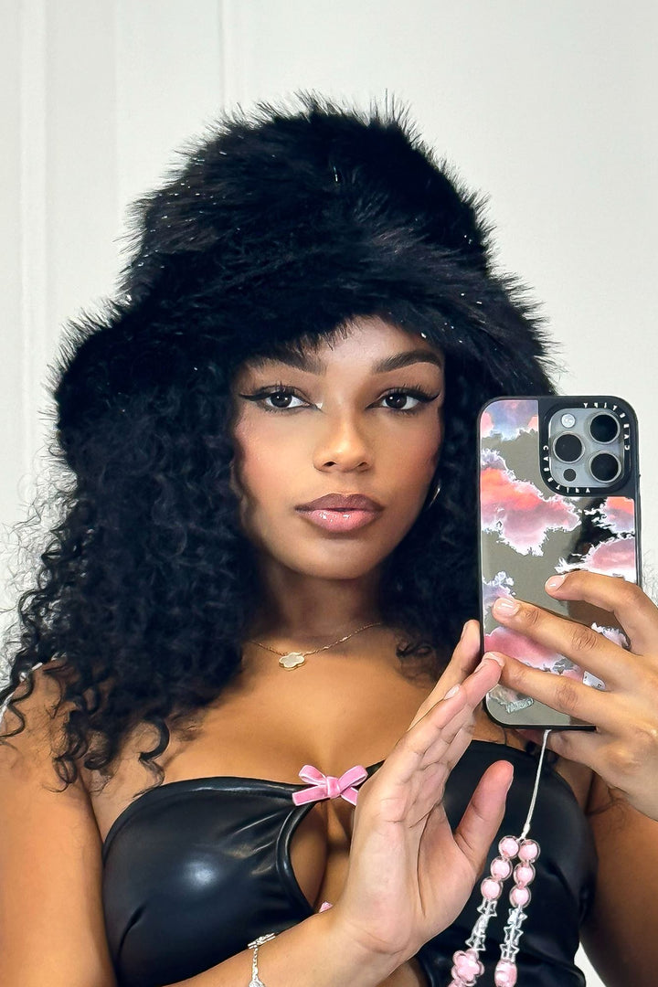 EDGE — black faux fur bucket hat worn by a model in a mirror selfie