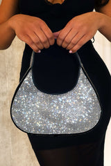 EDGE — black rhinestone-embellished shoulder bag held by a model in a black dress