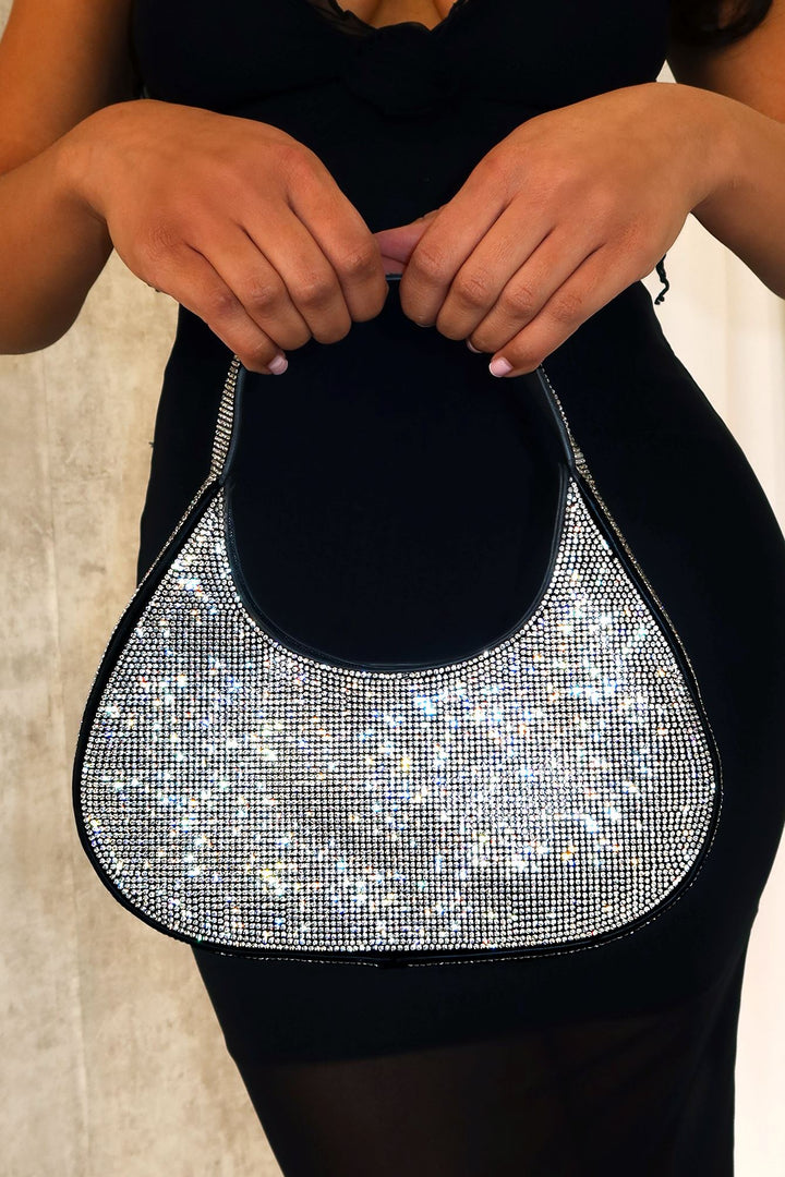 EDGE — black rhinestone-embellished shoulder bag held by a model in a black dress