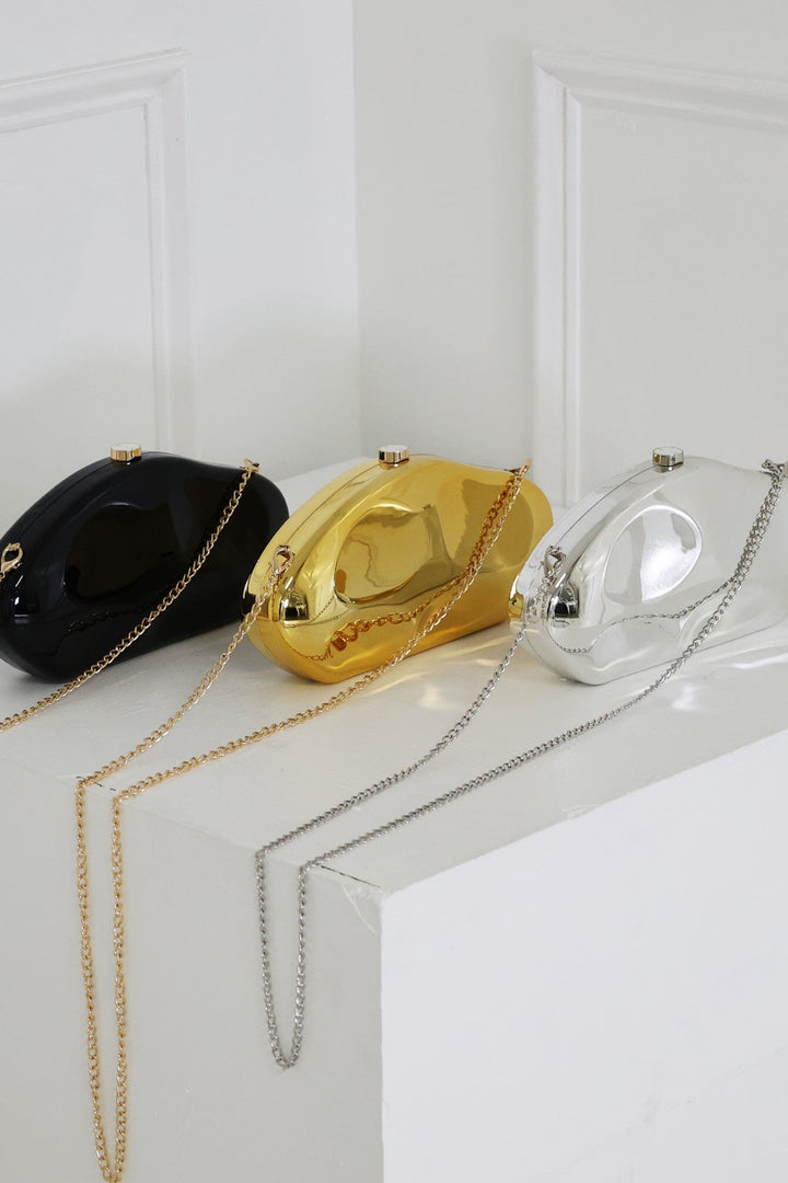 EDGE — black, gold, and silver mirror-plated mini clutches displayed together, flat lay