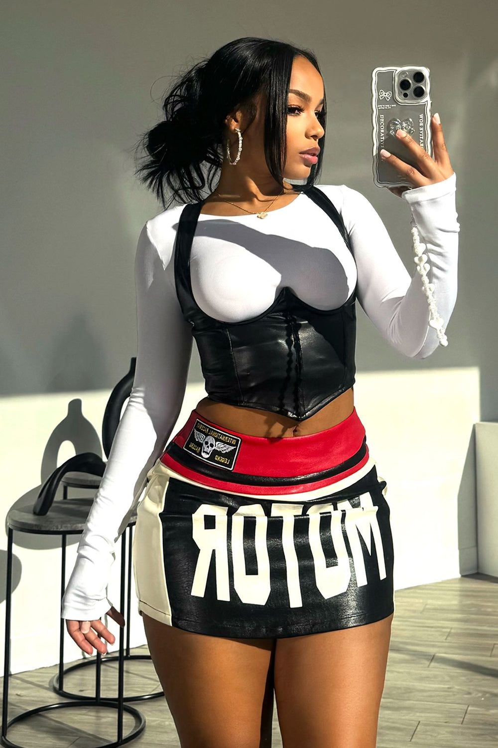 EDGE — black faux leather corset with crisscross straps, side view mirror selfie on model