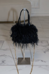 EDGE — black faux fur mini bag displayed on a stand, front view flat lay