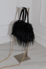 EDGE — black faux fur mini bag displayed on a stand, back view flat lay