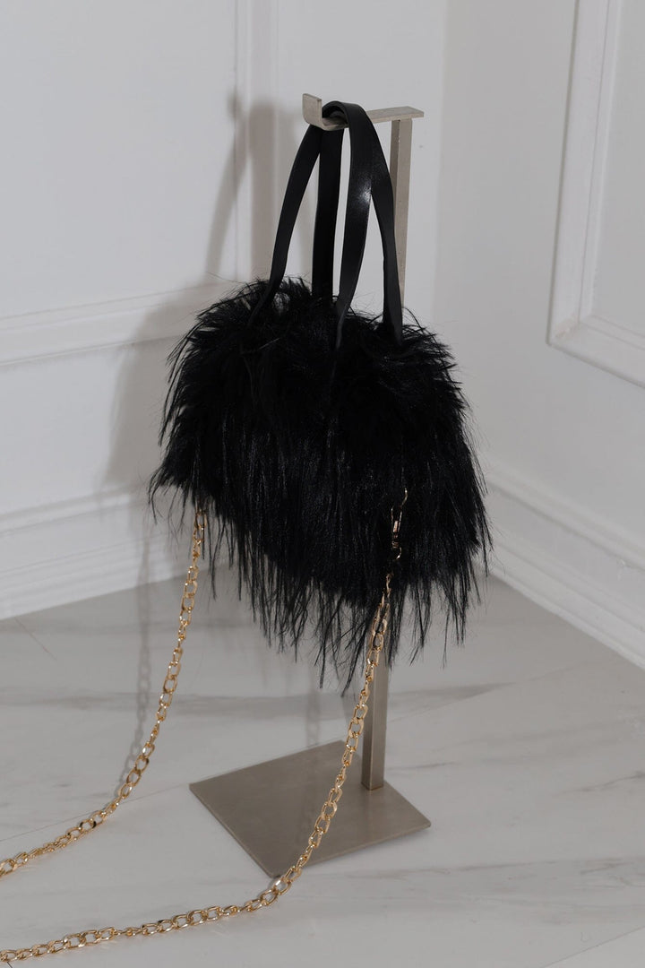 EDGE — black faux fur mini bag displayed on a stand, back view flat lay