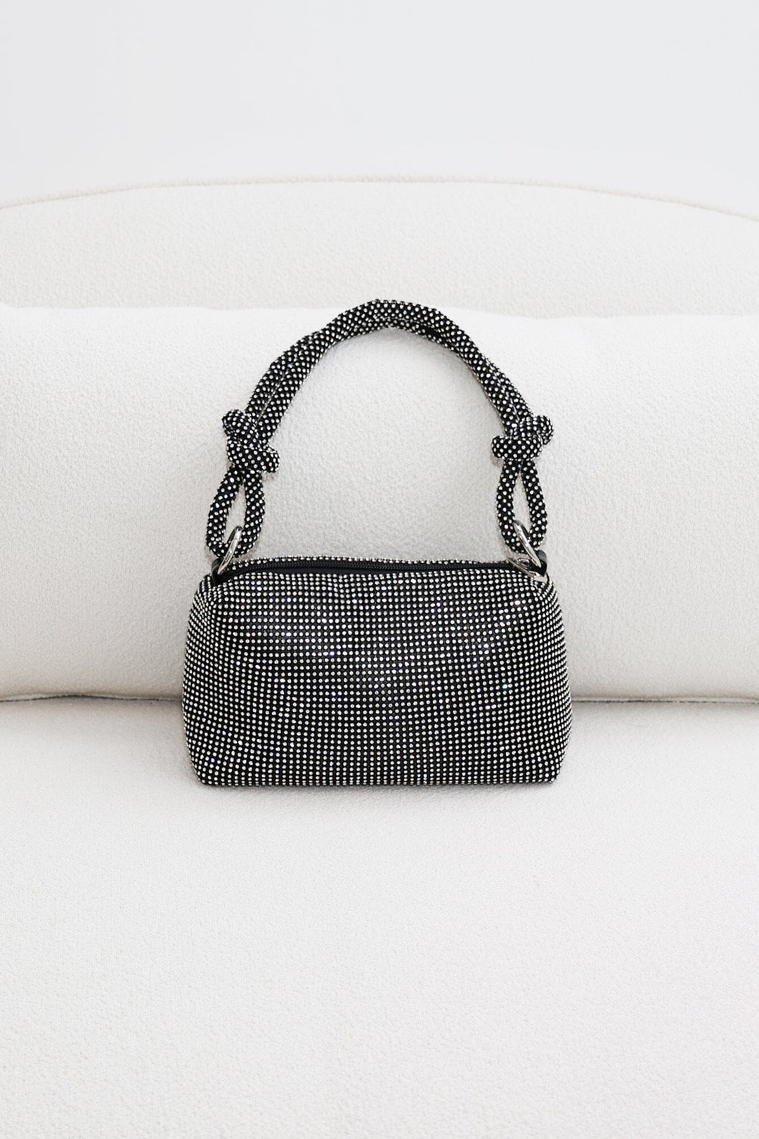 EDGE — black rhinestone-embellished top handle evening bag, front view flat lay