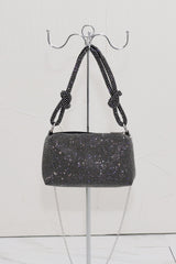 EDGE — black rhinestone-embellished top handle evening bag displayed on a stand
