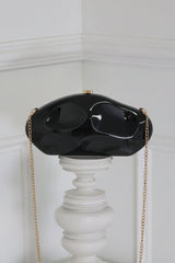 EDGE — black mirror-plated mini clutch displayed on a pedestal, front view flat lay