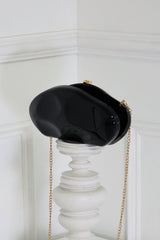 EDGE — black mirror-plated mini clutch displayed on a pedestal, side angle flat lay