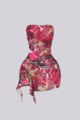 Sheer mesh tube mini dress with bold side cutout with metal ring detail
Asymmetric flowing hem creates a sculpted silhouette