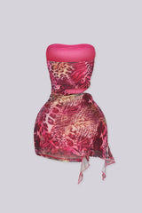 Sheer mesh tube mini dress with bold side cutout with metal ring detail
Asymmetric flowing hem creates a sculpted silhouette