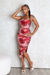 EDGE — red floral print ruched midi dress with a side slit, front view on model