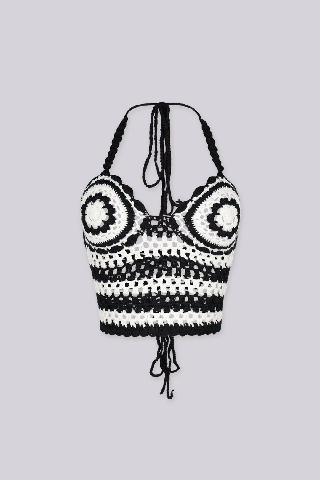 Boho inspired black and white crochet halter crop top featuring circular bust motifs