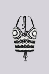 Boho inspired black and white crochet halter crop top featuring circular bust motifs