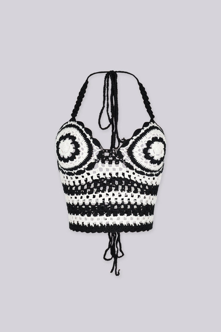 Boho inspired black and white crochet halter crop top featuring circular bust motifs