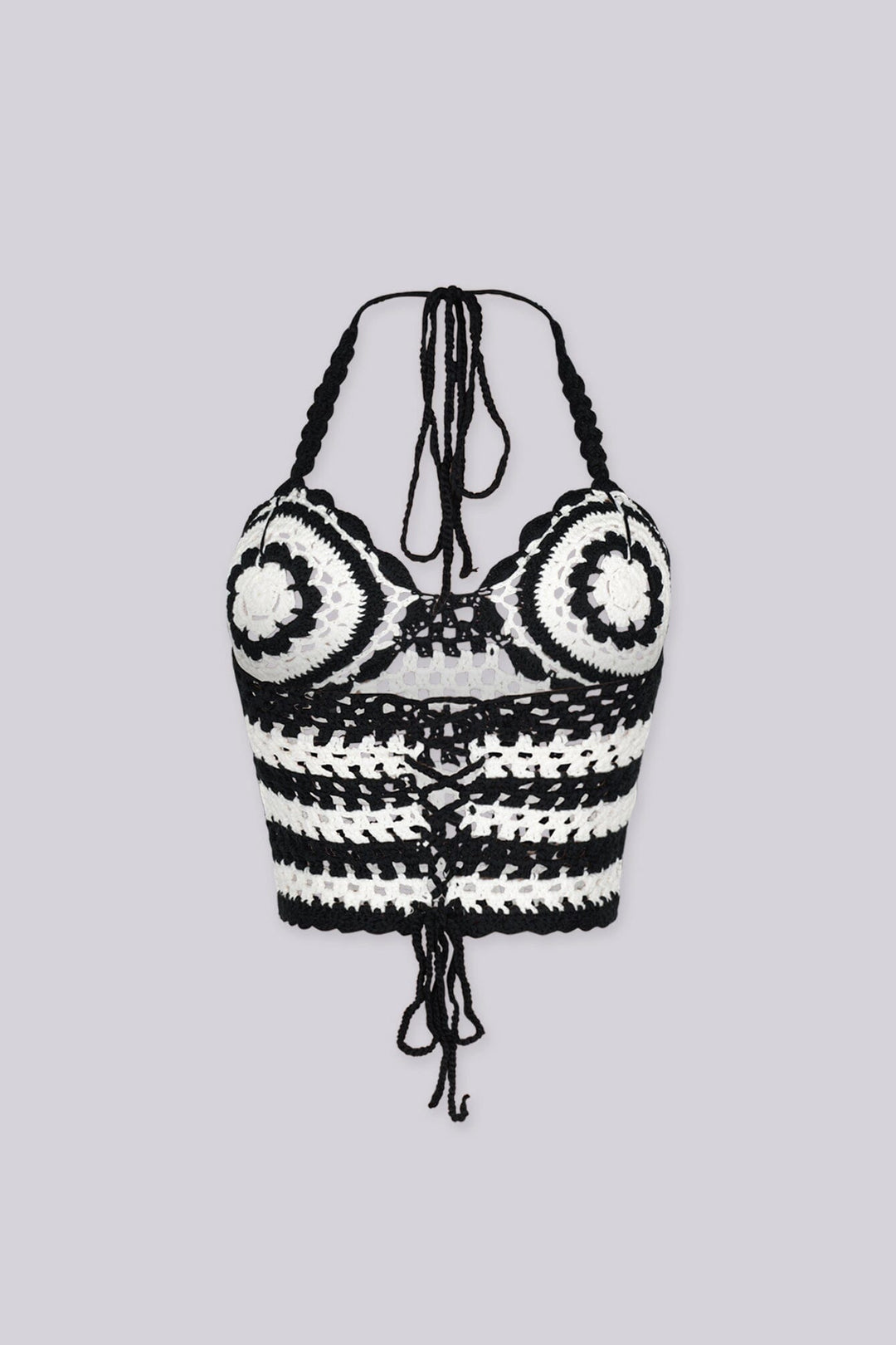 Boho inspired black and white crochet halter crop top featuring circular bust motifs