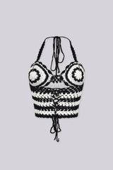 Boho inspired black and white crochet halter crop top featuring circular bust motifs