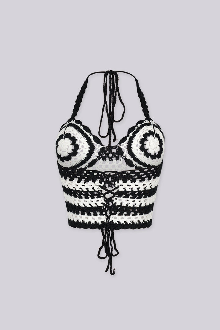Boho inspired black and white crochet halter crop top featuring circular bust motifs