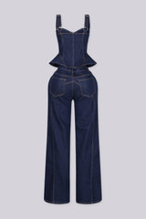 Denim bustier top with adjustable shoulder straps and vertical boning seams featuring peplum hem that flares at the hip