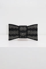 EDGE — black rhinestone bow-shaped evening clutch, front view flat lay