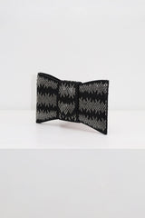 EDGE — black rhinestone bow-shaped evening clutch, angled view flat lay