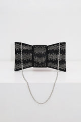 EDGE — black rhinestone bow-shaped evening clutch with chain strap, flat lay