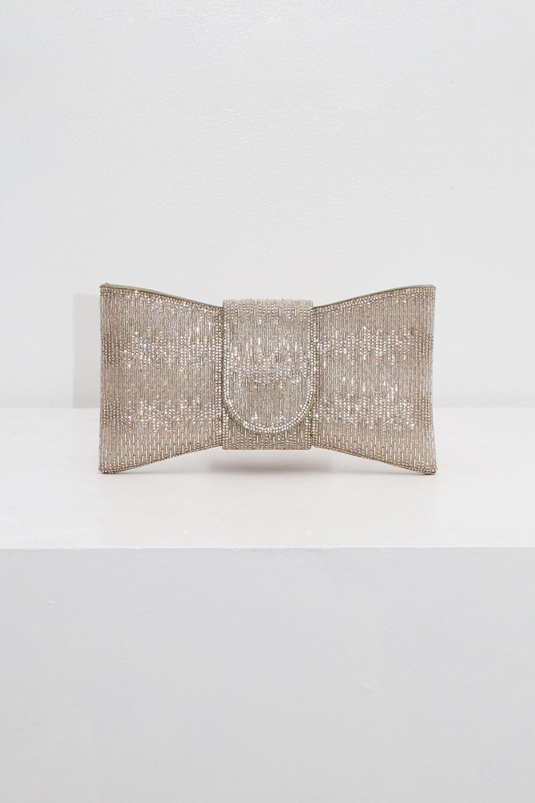 EDGE — gold rhinestone bow-shaped evening clutch, front view flat lay