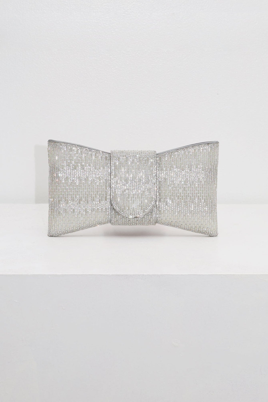 EDGE — silver rhinestone bow-shaped evening clutch, front view flat lay