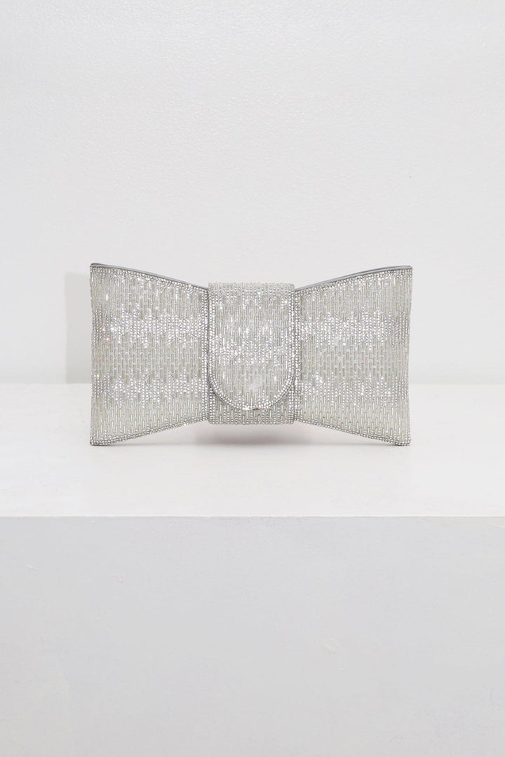 EDGE — silver rhinestone bow-shaped evening clutch, front view flat lay