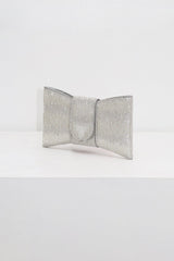 EDGE — silver rhinestone bow-shaped evening clutch, angled view flat lay