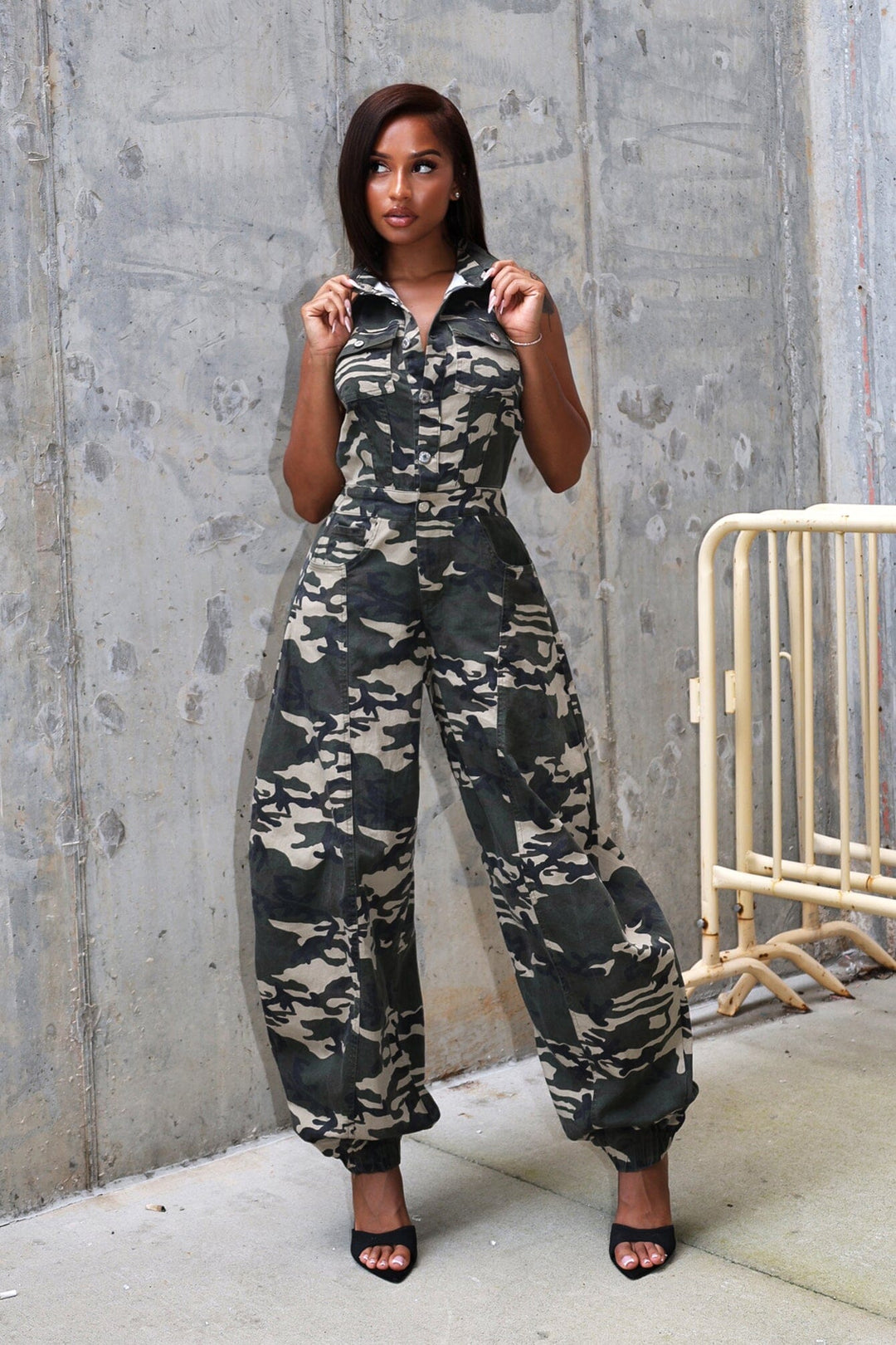 Camo print jogger jumpsuit with a button front closure and open back design, front view