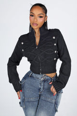 Cropped cable knit cardigan with a mock collar featuring epaulet shoulder detail and crest button trim