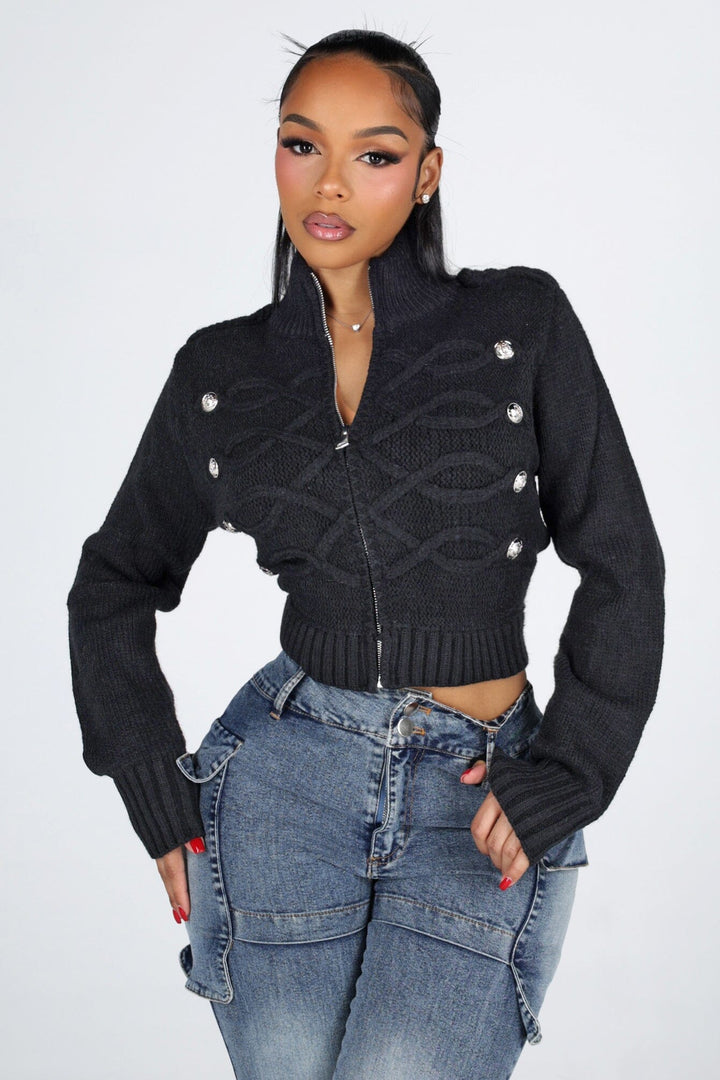 Cropped cable knit cardigan with a mock collar featuring epaulet shoulder detail and crest button trim