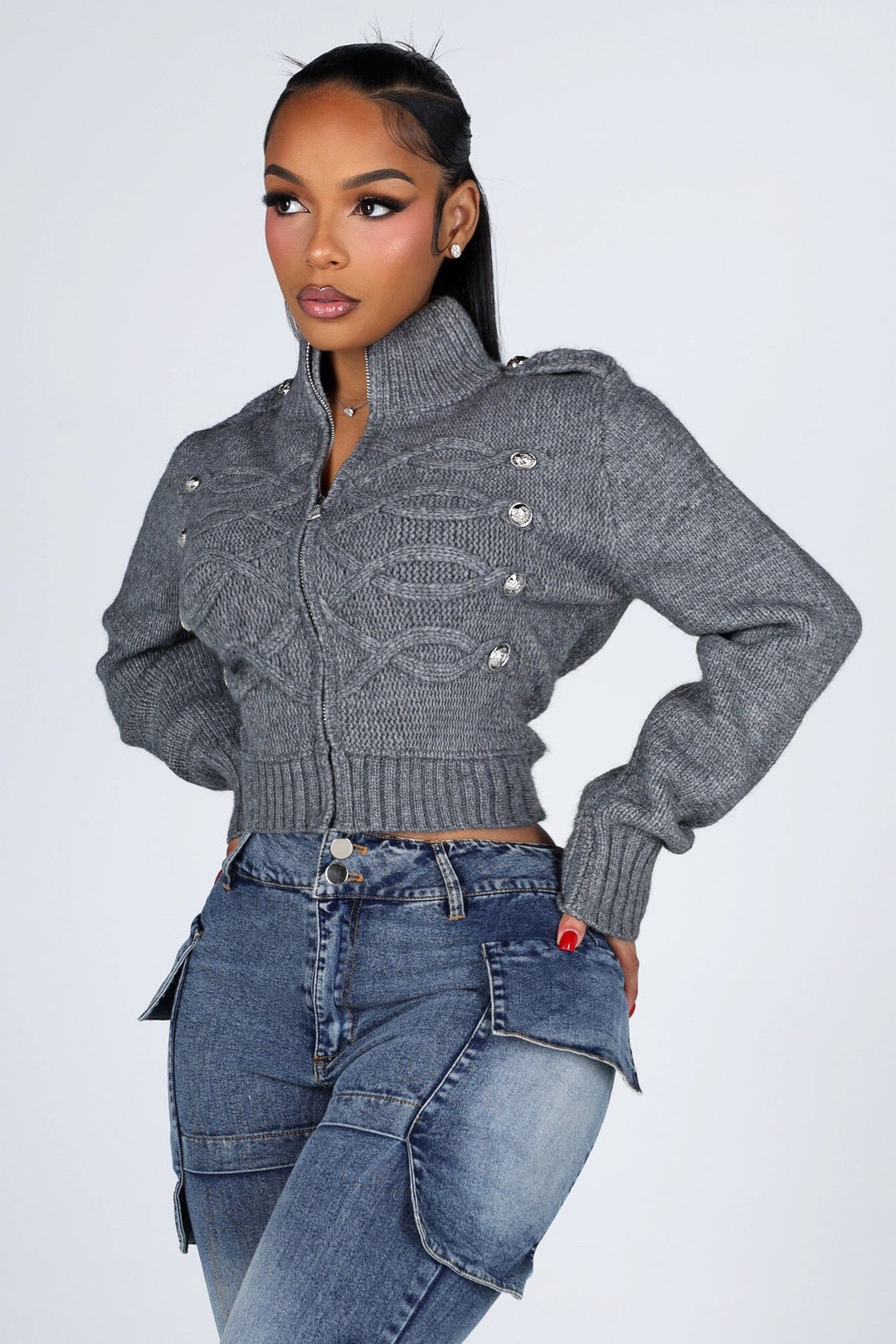 Cropped cable knit cardigan with a mock collar featuring epaulet shoulder detail and crest button trim