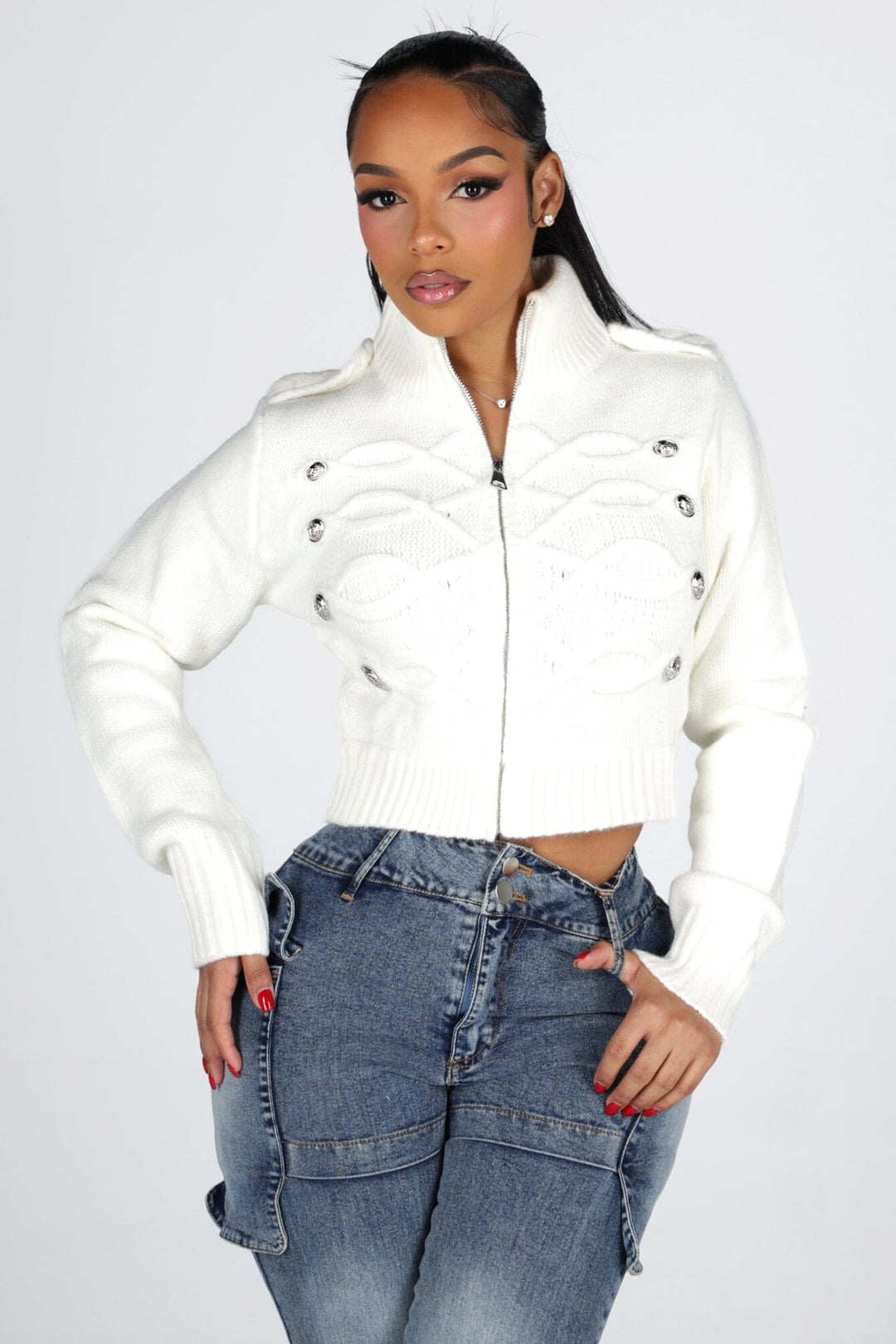Cropped cable knit cardigan with a mock collar featuring epaulet shoulder detail and crest button trim