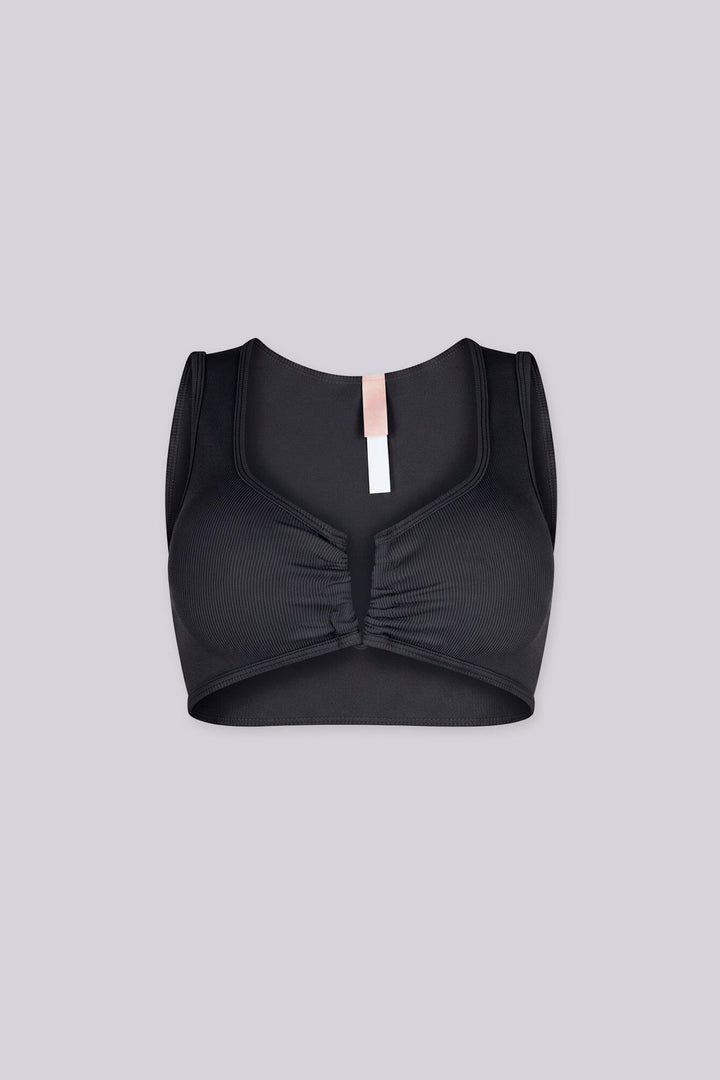 Ribbed knit crop tank top featuring V shape cutout at center front into a small ruched cinch