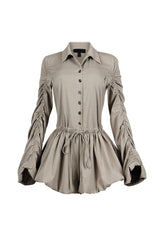 Pointed collared long sleeve romper with drawstring cinch waist with self tie bow featuring bubble hem skirt
Ruching along the outer shoulder seams  
