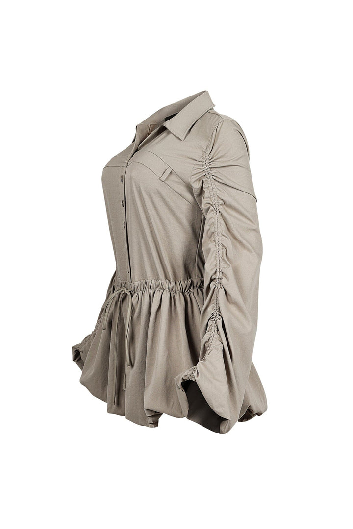Pointed collared long sleeve romper with drawstring cinch waist with self tie bow featuring bubble hem skirt
Ruching along the outer shoulder seams  