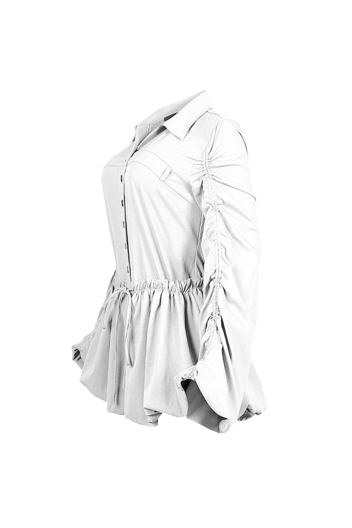 Pointed collared long sleeve romper with drawstring cinch waist with self tie bow featuring bubble hem skirt
Ruching along the outer shoulder seams  