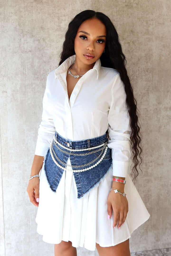 EDGE — denim blue pearl and chain draped belt worn over a white shirt dress, front view