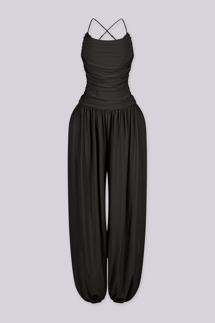 Tank top jumpsuit featuring draped cowl neckline with adjustable straps, Subtle horizontal ruched gathering across, Heavy gathering pants that taper at the bottom with elasticized ankle cuffs